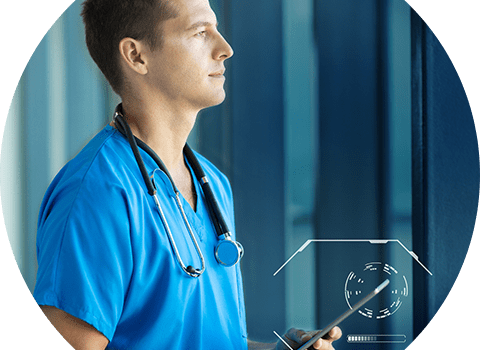 business-telecom-provider-image-Male doctor wearing blue scrubs and stethoscope holding an ipad