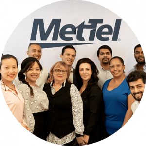 business-telecom-provider-image-Group of smiling men and women standing below the MetTel logo