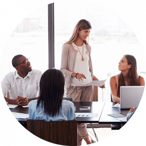 business-telecom-provider-image-Woman standing with three people sitting around a conference table