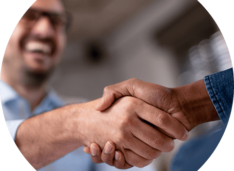 business-telecom-provider-image-Close up of handshake with man smiling in the background