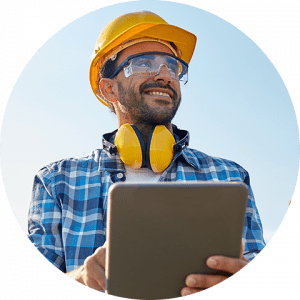 business-telecom-provider-image-Smiling bearded man wearing goggles and construction hat holding a clipboard