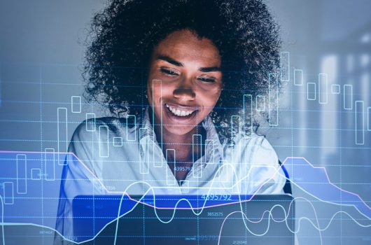 From 5G To AI And Network Security Hot Tech Trend Tips For 2021 - person on laptop with digital trend graphic overlay