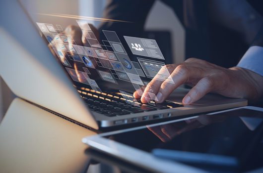 digital transformation journey hands typing on laptop with digital interface overlay