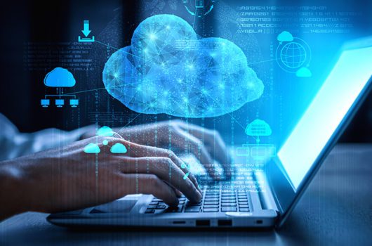 person typing on laptop with digital cloud overlay