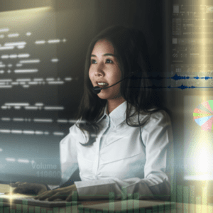 woman with headset sits in front of computer